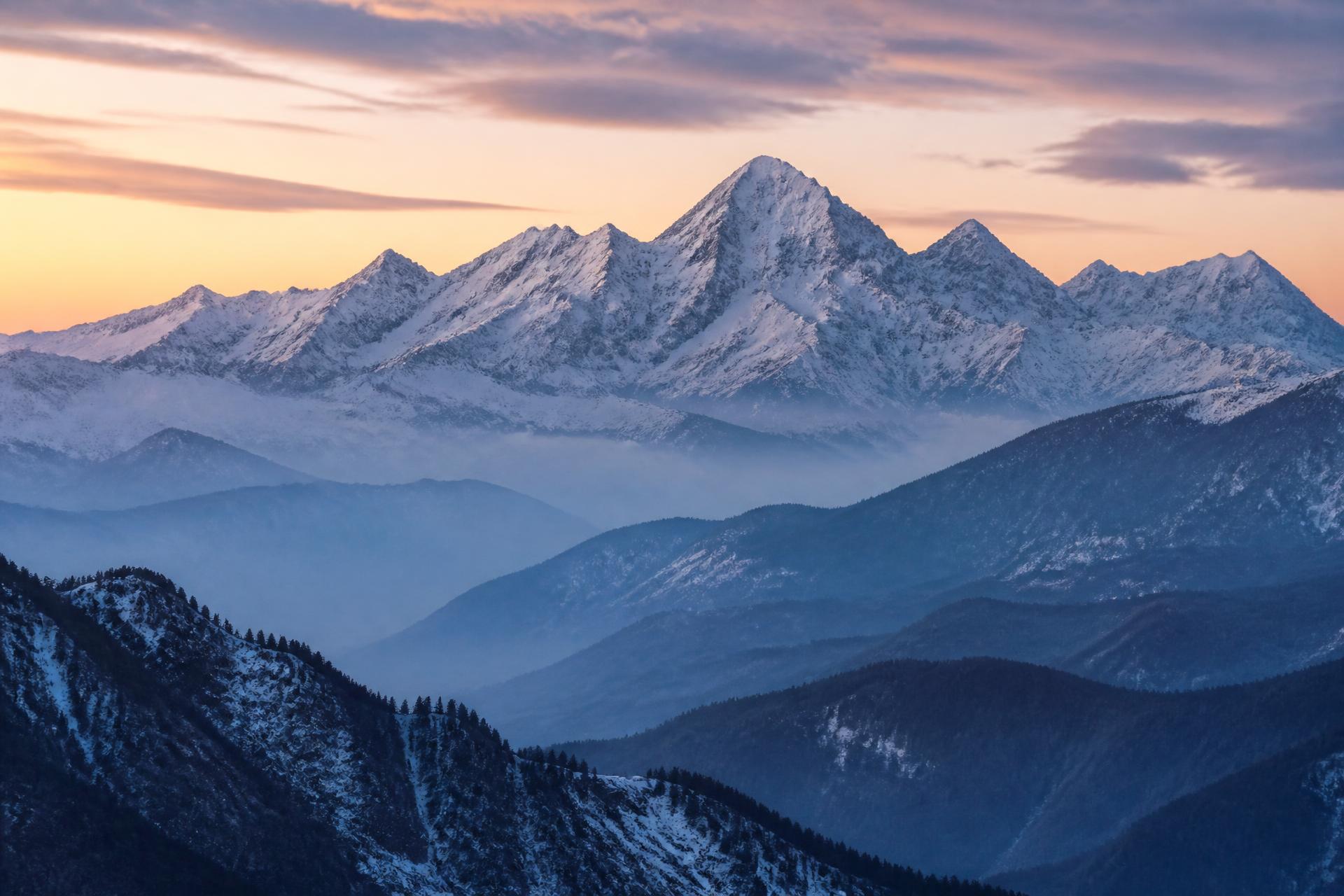 Snow-capped winter mountain range in soft atmospheric light, representing the enduring strength of Blackstone Investment Group
